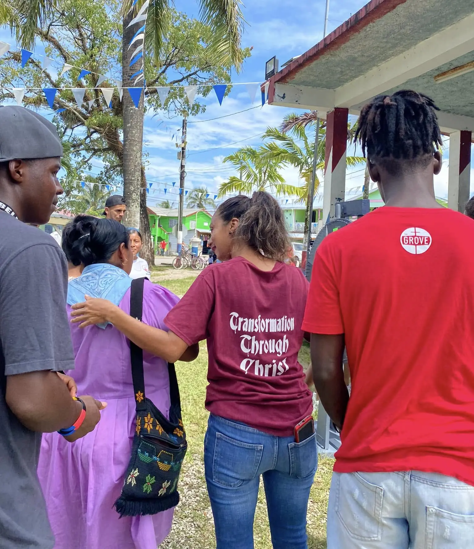 Church members praying with a neighbor during street outreach